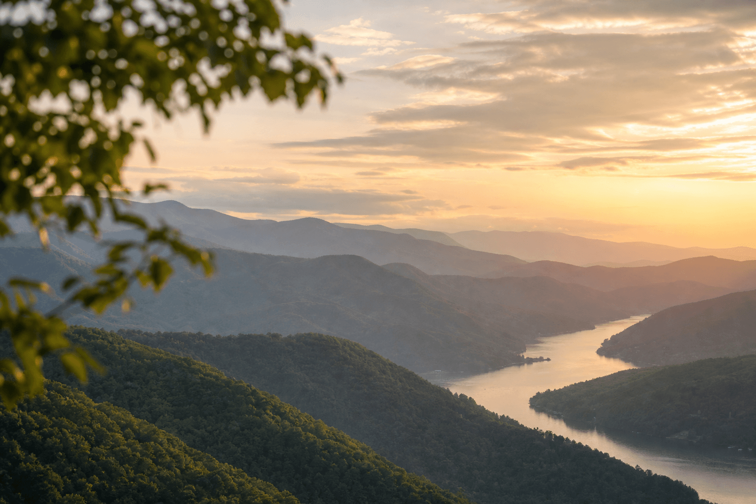 Sunrise over misty blue-green mountains